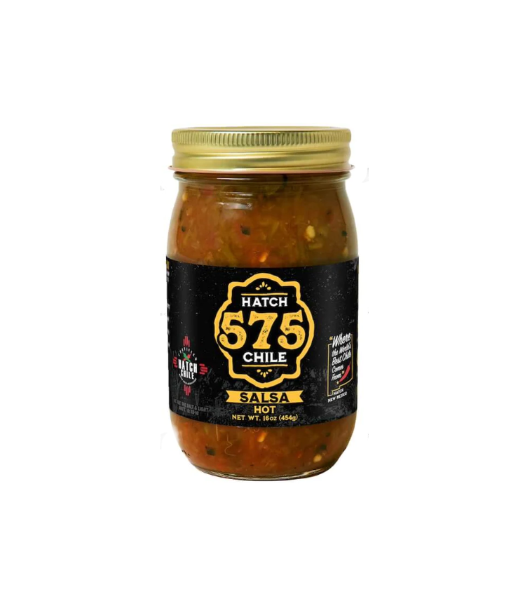 A jar of Hatch 575 Southwestern brand Hatch Green Chile Salsa, labeled medium heat and featuring flame-roasted chiles from the Hatch Valley. The jar is sealed and contains 16 oz of.