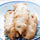 Battered Hatch green chile rellenos stacked on a decorative plate