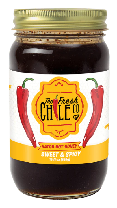 A jar of Hatch Hot Honey labeled "sweet & spicy," containing 16 oz (565g) with two red chilies depicted on the label.