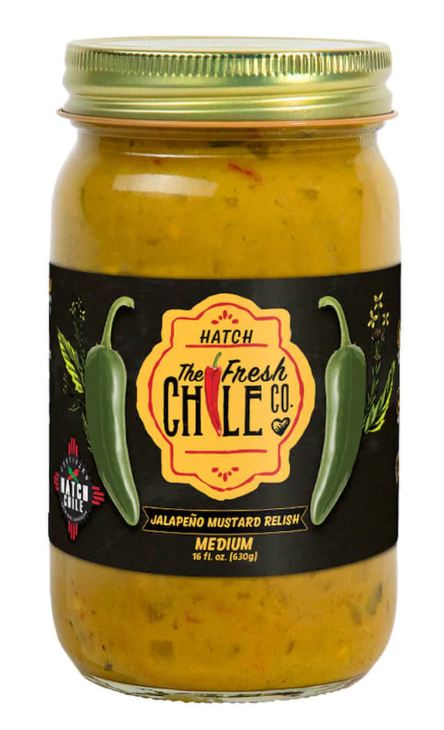 A jar of "Hatch Jalapeño Mustard Relish" labeled as medium spice, 16 oz, adorned with two green chili graphics on a yellow mustard background.