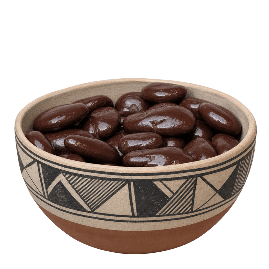 Dark chocolate covered pecans in a decorated New Mexico pottery bowl