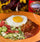 Red chile enchiladas topped with a fried egg, made with Ol' Gringo Red Chile Sauce