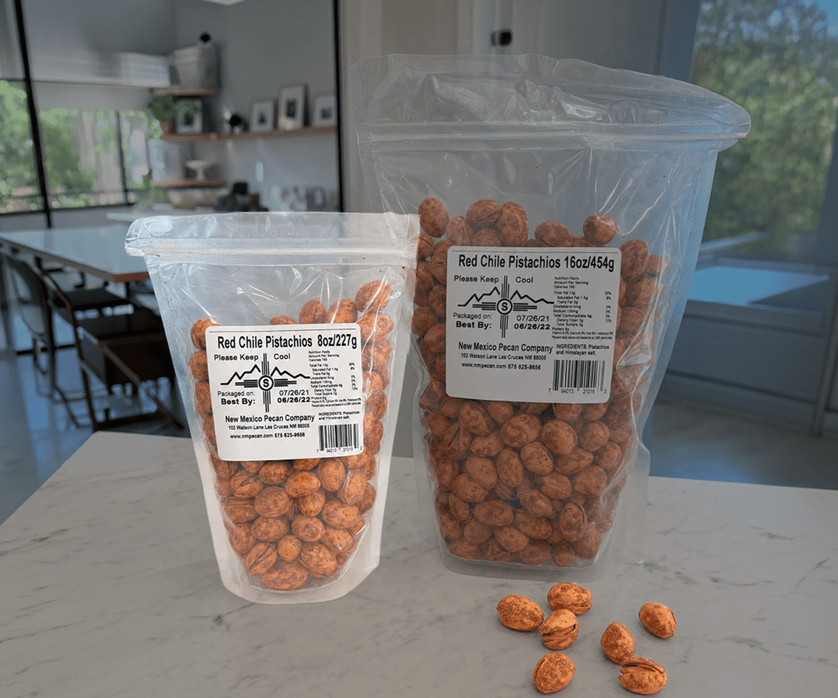 Red chile pistachios in 8 oz and 16 oz resealable bags on a counter