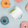 Get Roasted Coffee Mug — glossy ceramic mug, 11 oz in white, surrounded by donuts