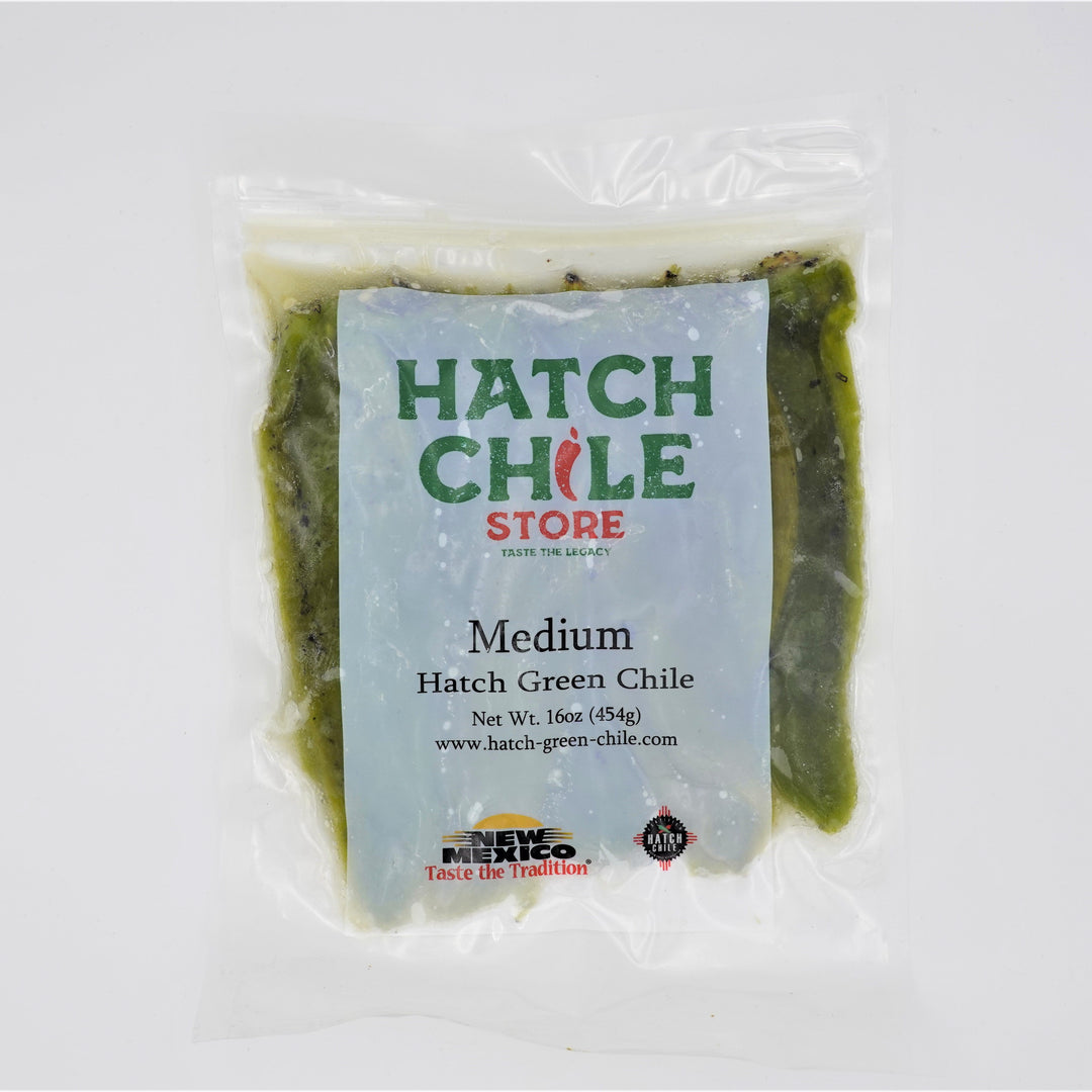 A packaged 16 oz. vacuum-sealed bag of Roasted Hatch Green Chile from the hatch chile store, with a blue and white label, prominently displayed on a plain white background