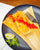 Hatch chile tamale topped with red chile sauce, with lime and cilantro