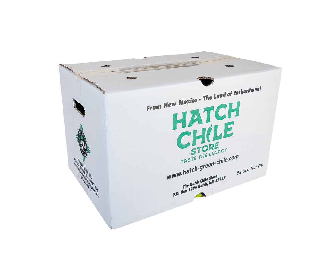 A white cardboard box labeled "hatch chile store" with text promoting Fresh Hatch Red Chile from New Mexico; phrases include "taste the legacy" and contact details.