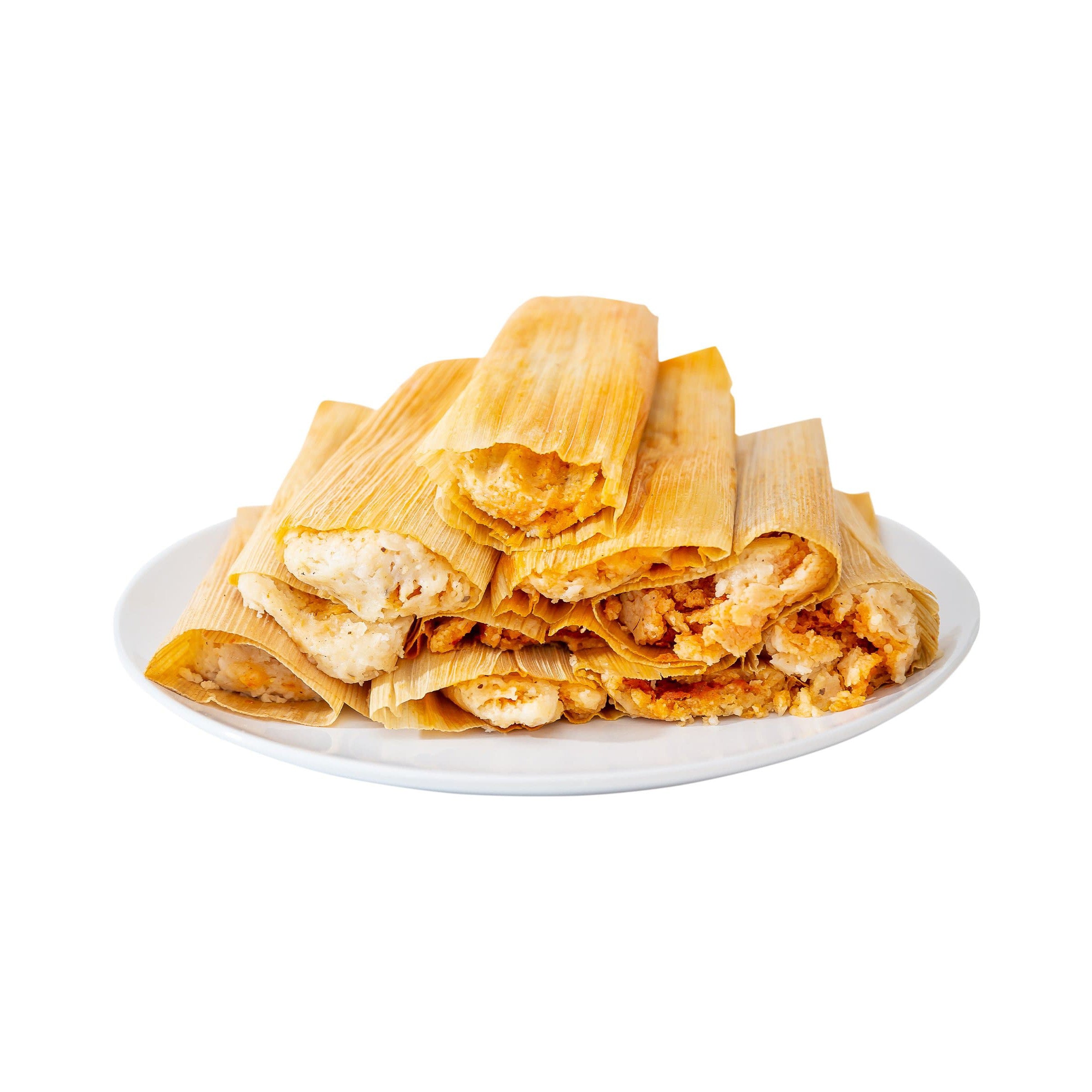 A plate full of freshly made Hatch Red Chile Pork Tamales, wrapped in corn husks, with visible fillings of shredded pork and spices, on a white background.