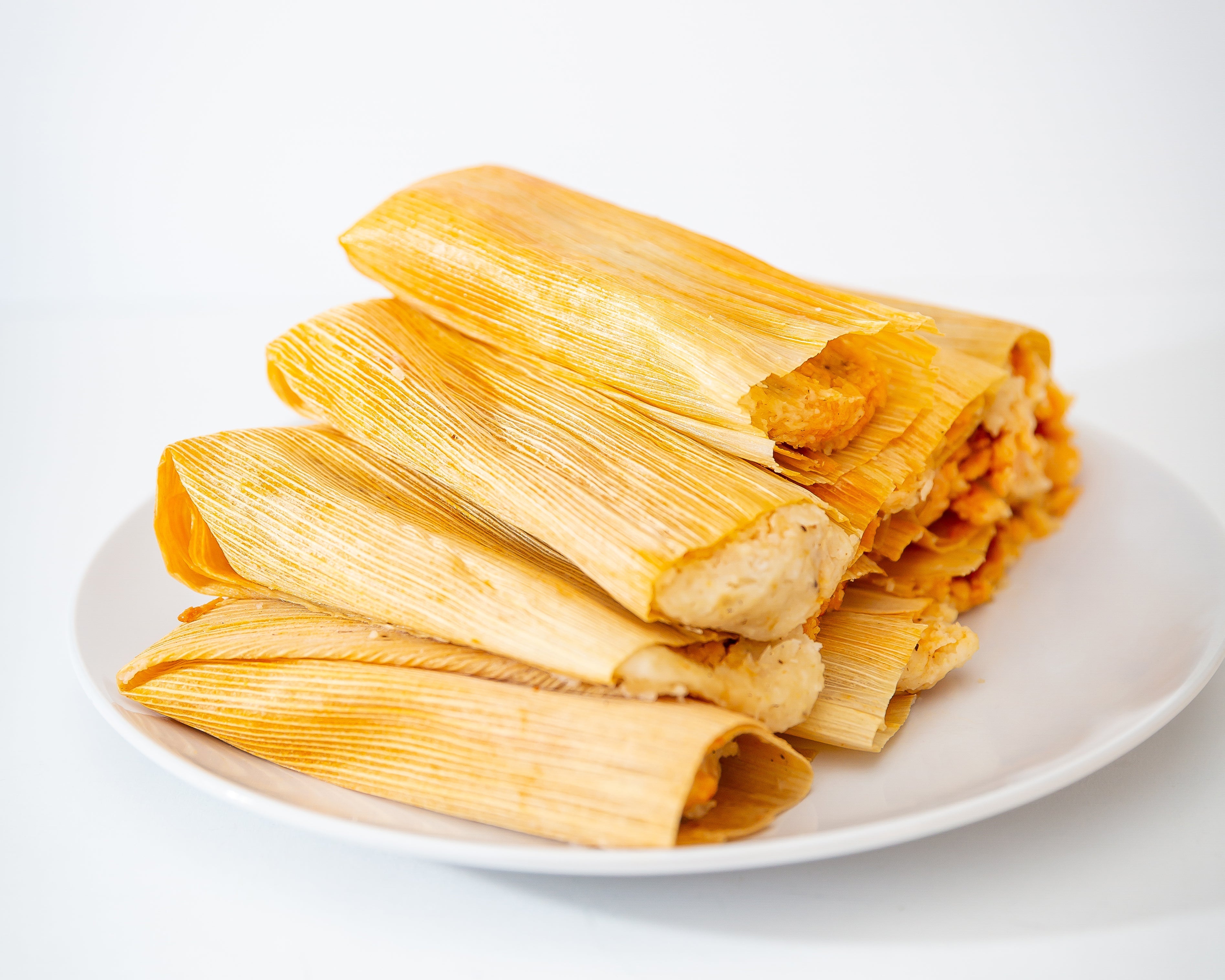 Three plates of Tamale Trio Sampler - HGCS