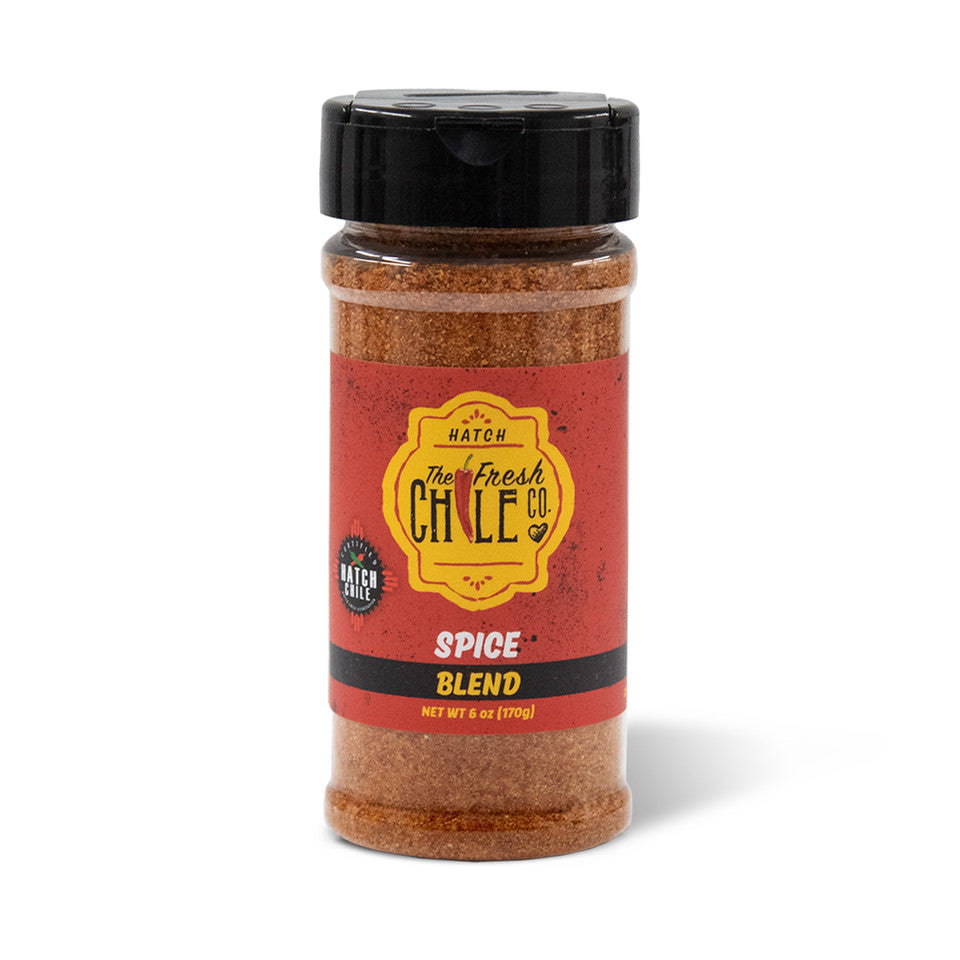 A jar of Hatch Red Chile Spice Blend with a black lid, featuring a predominantly red and yellow label against a white background.
