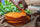 Hand picking up a crispy Hatch red chile corn tortilla from a stack