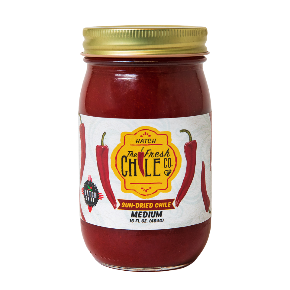 A jar of Sun-Dried Red Chile sauce, medium spice level, with a label featuring red chili peppers. The jar contains 16 oz. of sauce.