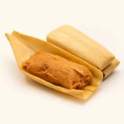 Hatch red chile pork tamales in corn husks