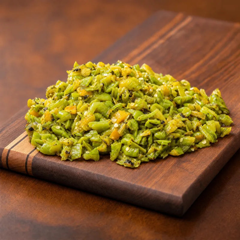 Chopped roasted Hatch green chile on a wooden cutting board.