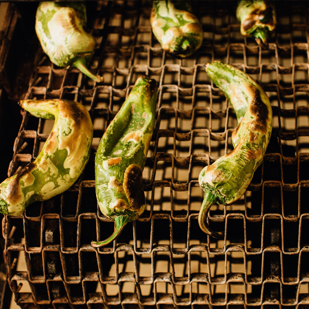 Roasting fresh Hatch green chile in a flame roaster