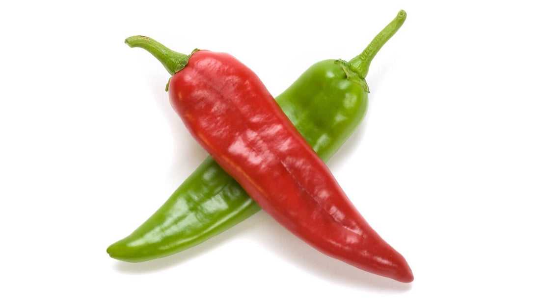 One red chile pod crossed over one green chile pod on a white background