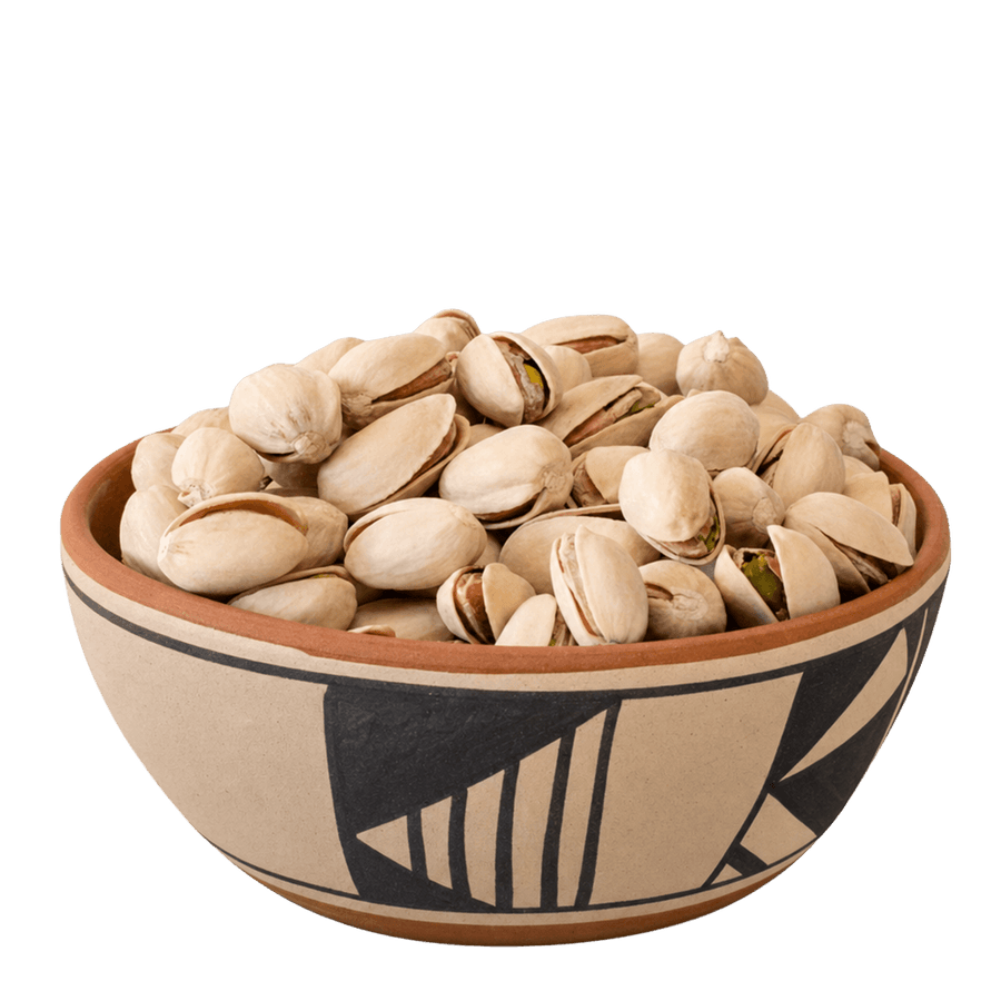 Roasted salted pistachios in shells in a Pueblo-patterned ceramic bowl
