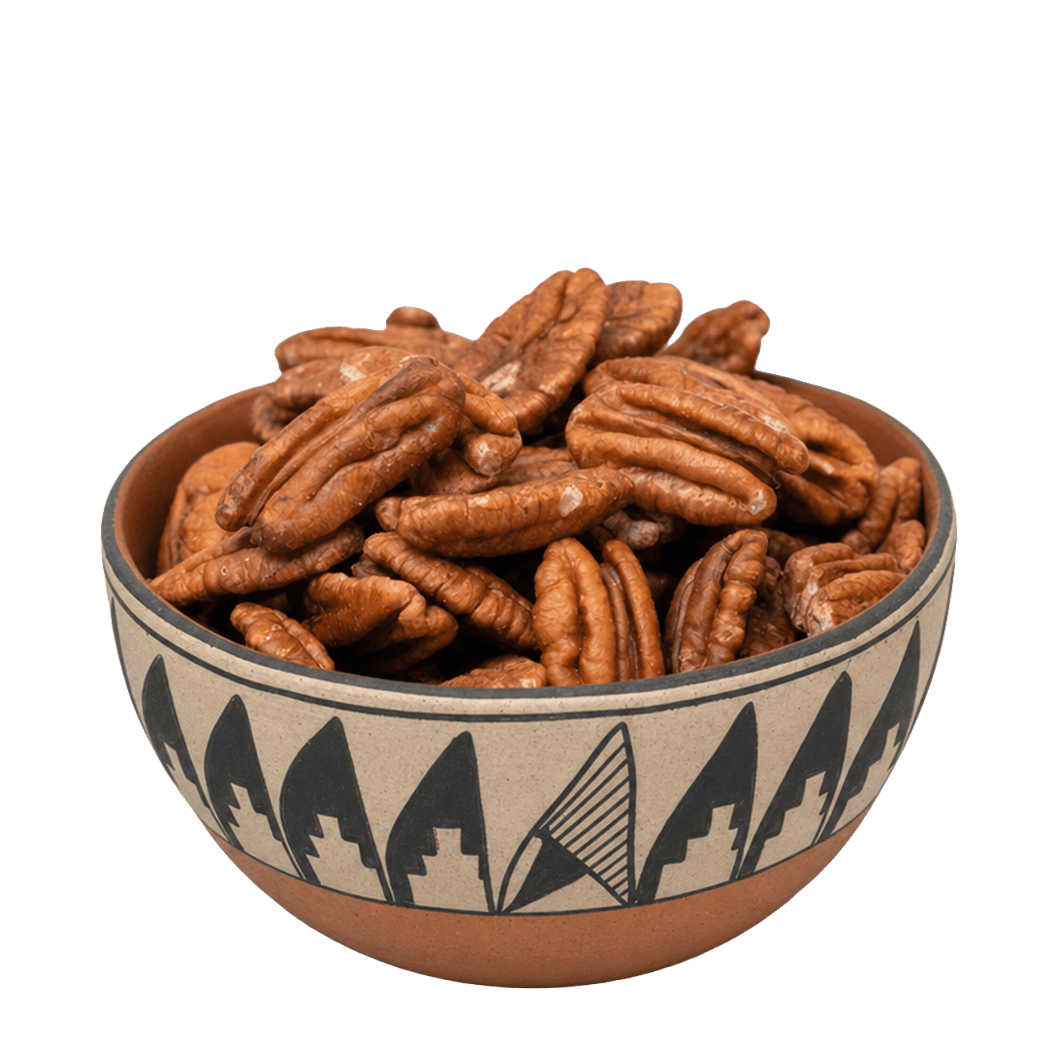 Pecan halves in a Southwestern pottery bowl with black geometric pattern