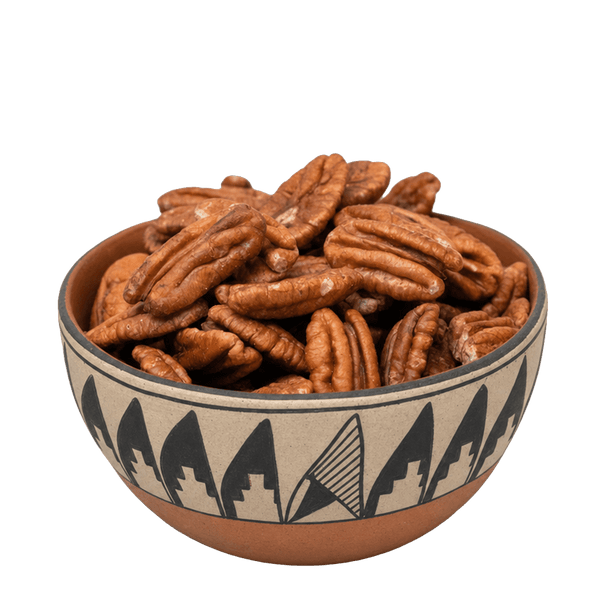 Pecan halves in a Southwestern pottery bowl with black geometric pattern