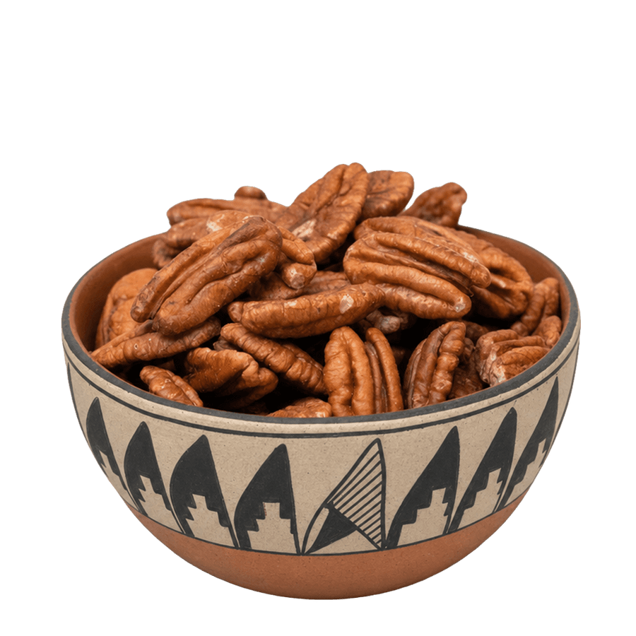 Pecan halves in a Southwestern pottery bowl with black geometric pattern