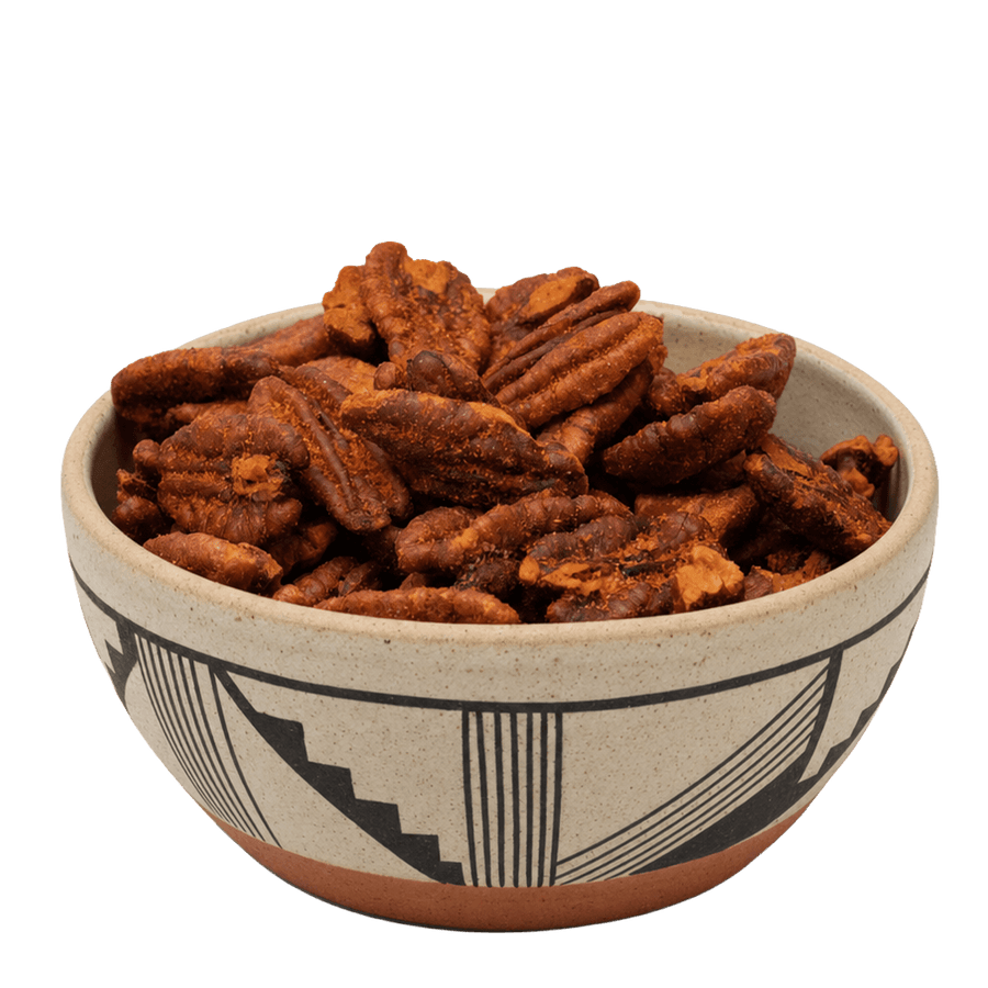 Red chile pecans in a Southwestern black-and-tan patterned ceramic bowl