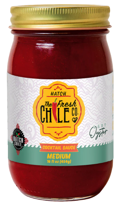 A jar of Hatch Chile cocktail sauce labeled "medium" heat, containing 16 fl oz (454 g). The jar's label is colorfully designed with vibrant red and green accents.