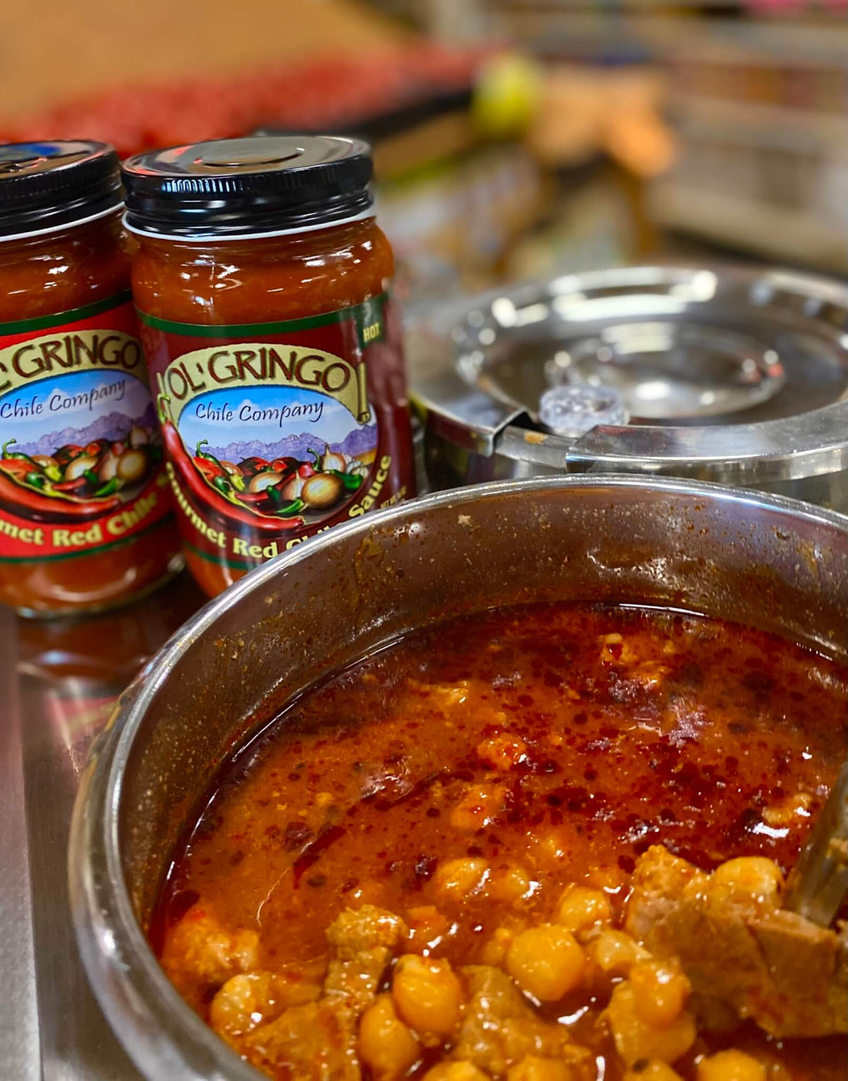 Posole simmering with Ol' Gringo Red Chile Sauce jars