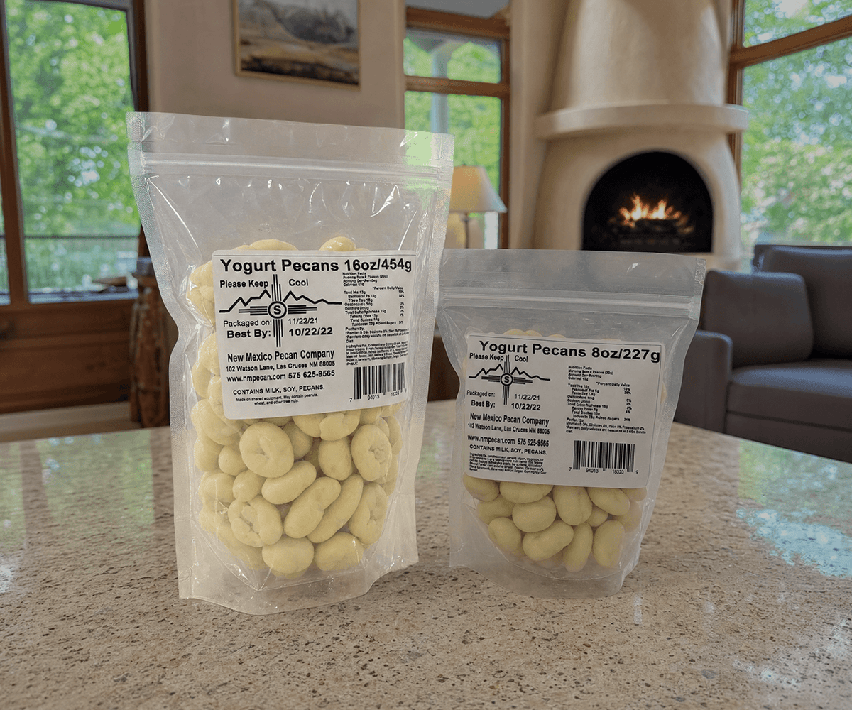 Yogurt-covered pecans in 16 oz and 8 oz clear resealable bags on a counter