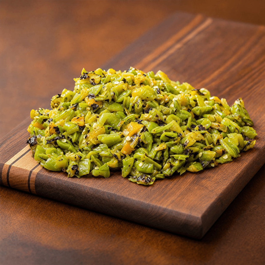 Chopped roasted Hatch green chile piled on a wooden cutting board