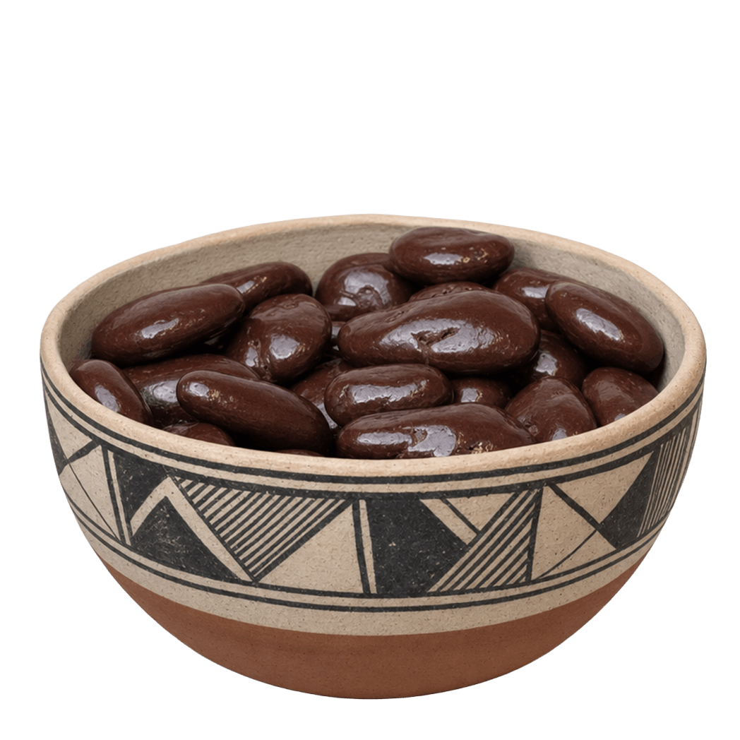 Dark chocolate covered pecans in a decorated New Mexico pottery bowl