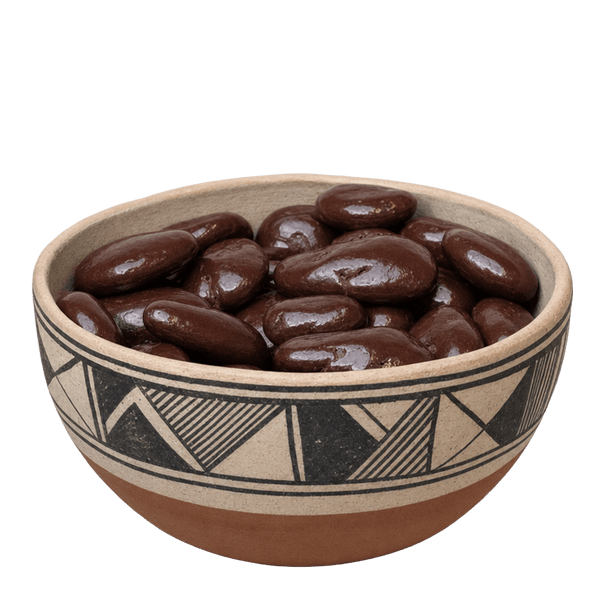 Dark chocolate covered pecans in a decorated New Mexico pottery bowl