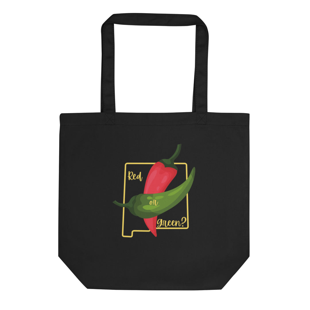 A black NM State Question Tote Bag featuring a colorful design with a red chili, a green chili, and the text "red or green?" enclosed in a decorative frame.