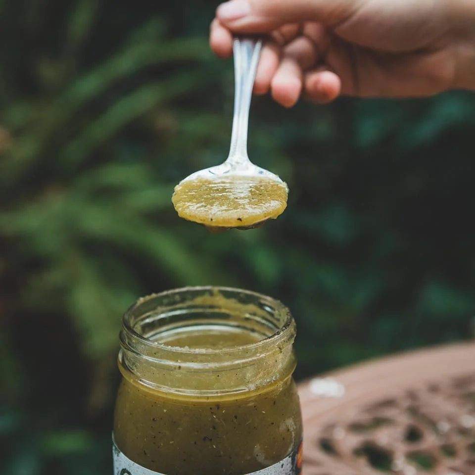 Hatch Green Chile Sauce being scooped from the jar.