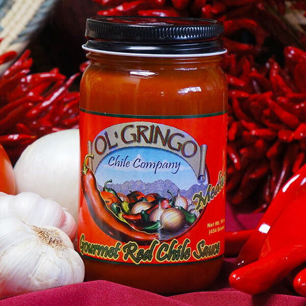 Ol' Gringo Gourmet Red Chile Sauce jar with red chile ristras, garlic and onion