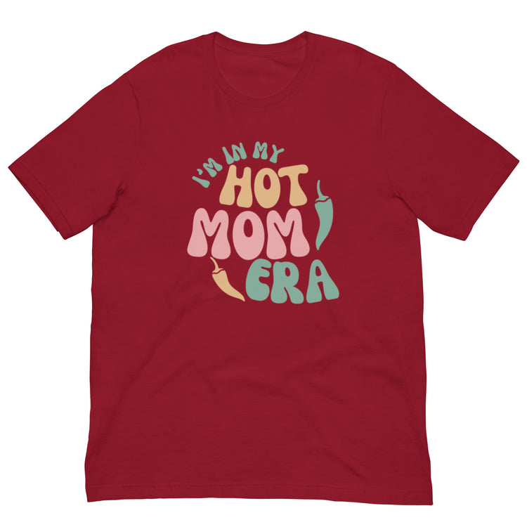 A red breathable Era Shirt with the phrase "in my hot mom era" printed in colorful, playful letters on the front.