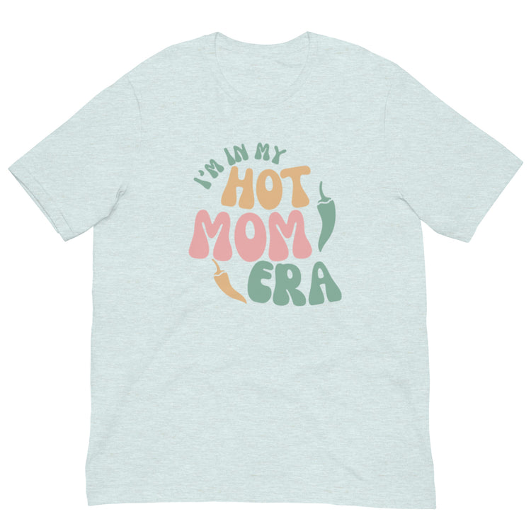 A light gray breathable Era Shirt with colorful text that reads "i'm in my hot mom era" in playful, bold fonts with pastel colors. The shirt is displayed on a plain white background.