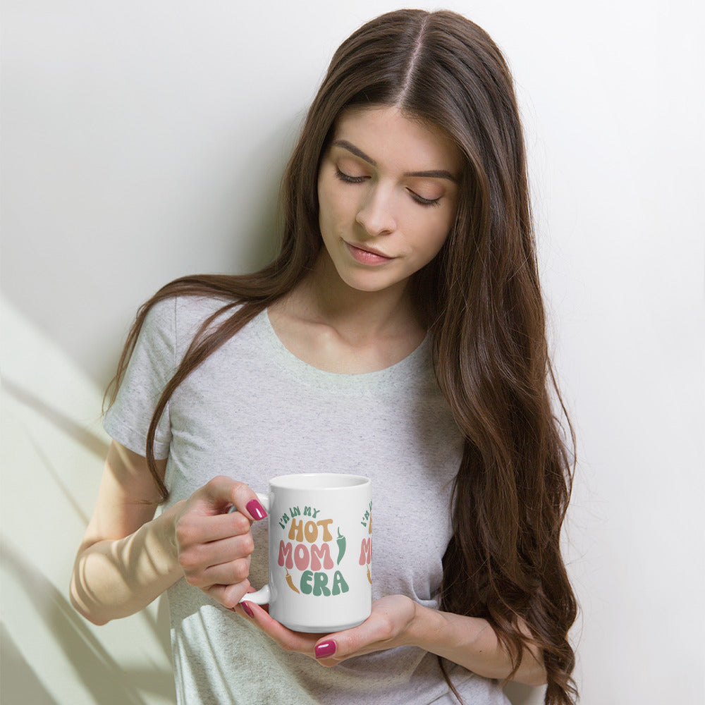 Era Mug — glossy ceramic mug, 15 oz in white, held by a model