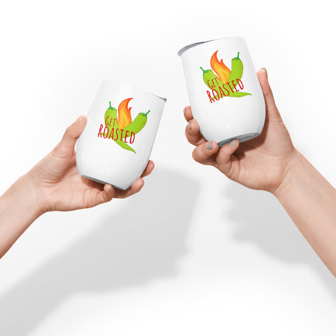 Two hands holding Get Roasted Wine Tumblers with the playful text "get roasted" and an illustration of a chili pepper on fire. The background is plain white.