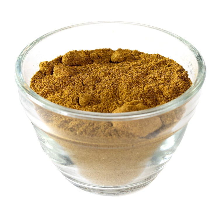 A clear glass bowl filled with Green Chile Powder, isolated on a white background.