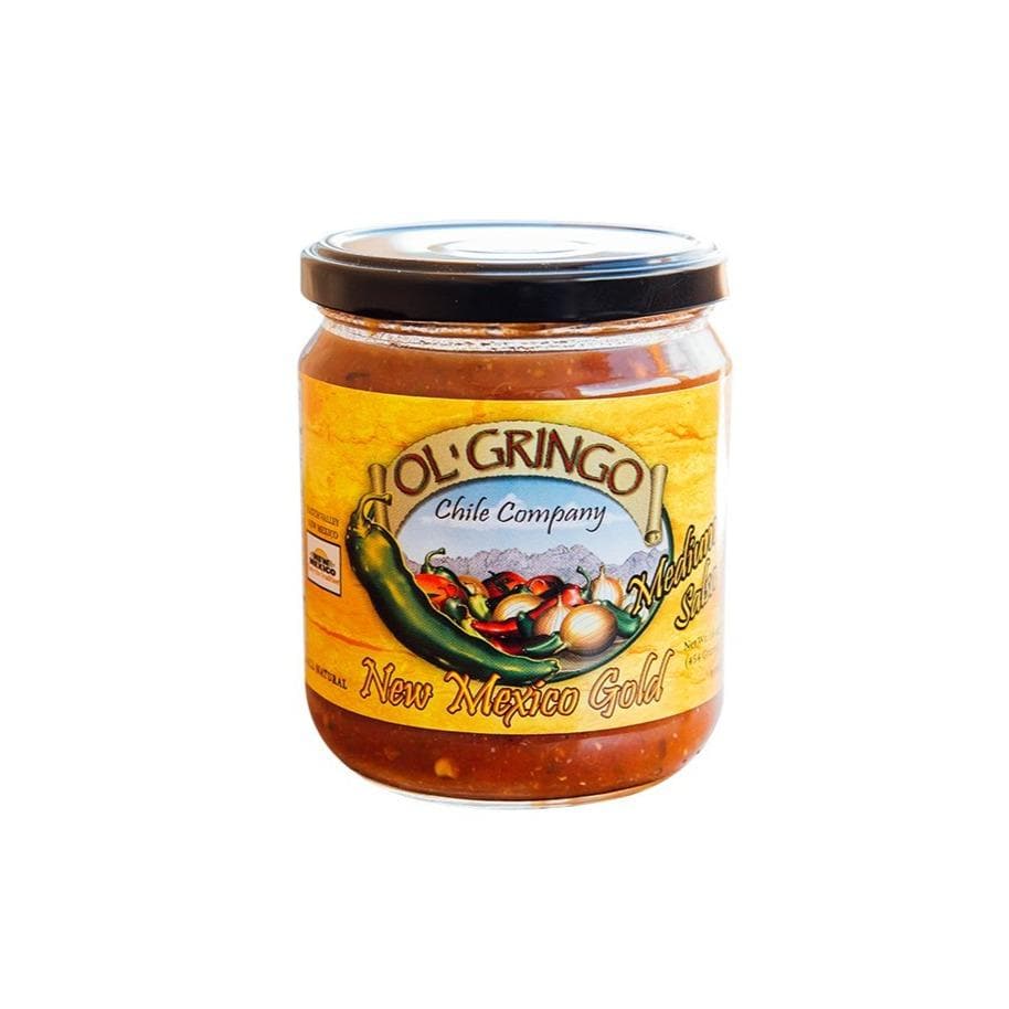 A glass jar labeled "New Mexico Gold Salsa" with "New Mexican salsa" and an illustration of peppers and garlic, containing yellowish-orange salsa, on a white background.