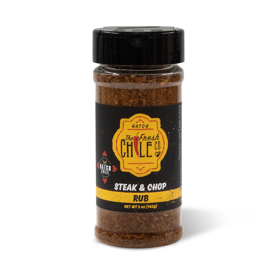 A jar of Hatch Red Chile Steak & Chop Rub from The Fresh Chile Co., labeled as Steak & Chop Rub, against a white background. The label features a vibrant yellow and black design.
