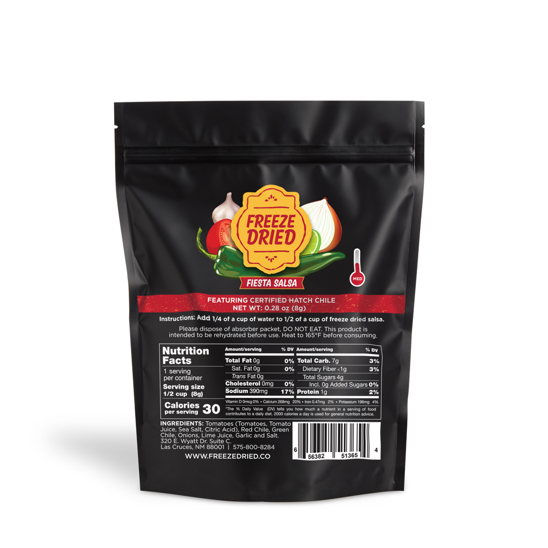 A bag of Freeze Dried Fiesta Salsa - 24 grams featuring certified hatch chile, with nutrient information and logos displayed on a predominantly black background with red and green accents.