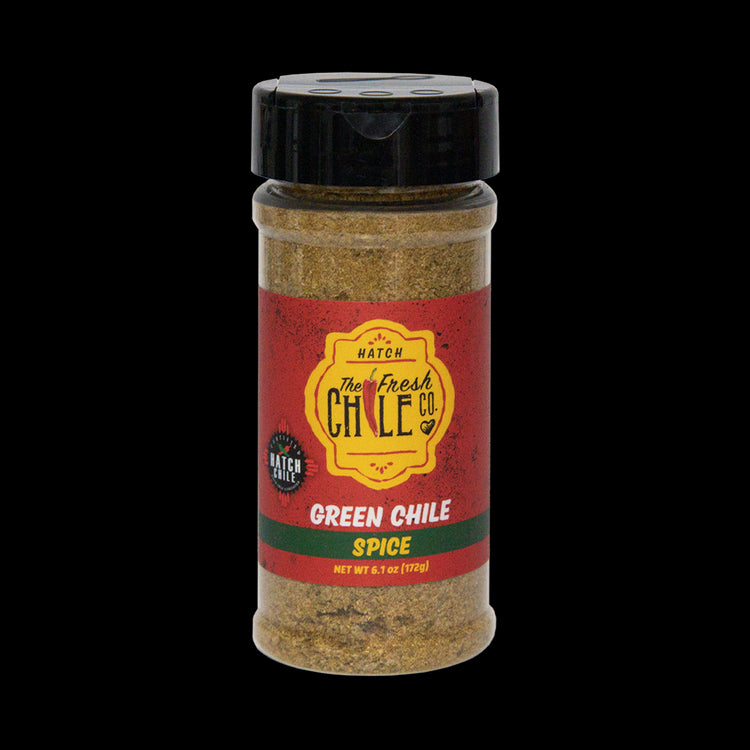 A clear shaker container of Hatch Green Chile Spice, labeled prominently with red and yellow colors, containing a visible blend of spices.