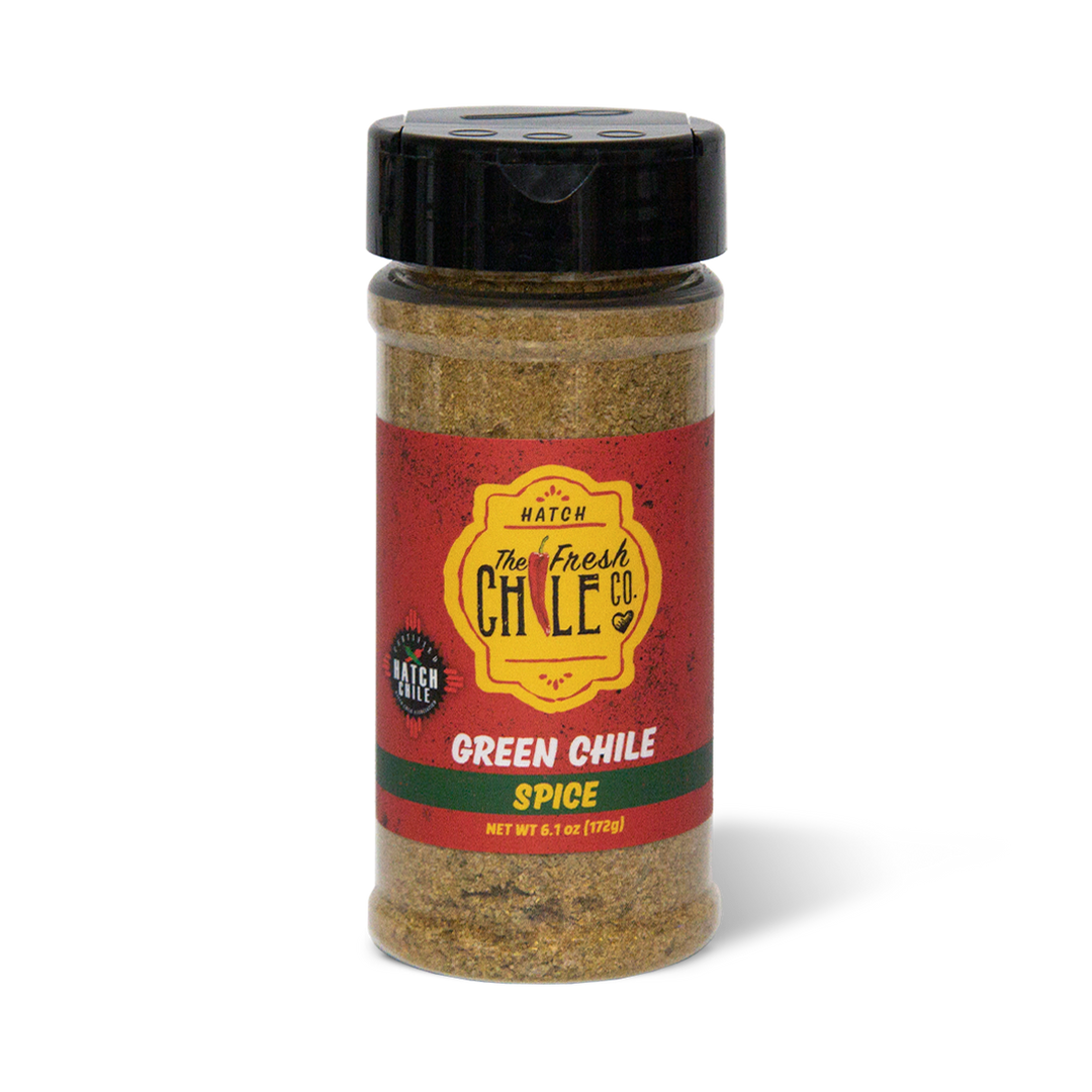 A clear shaker container of Hatch Green Chile Spice, labeled prominently with red and yellow colors, containing a visible blend of spices.