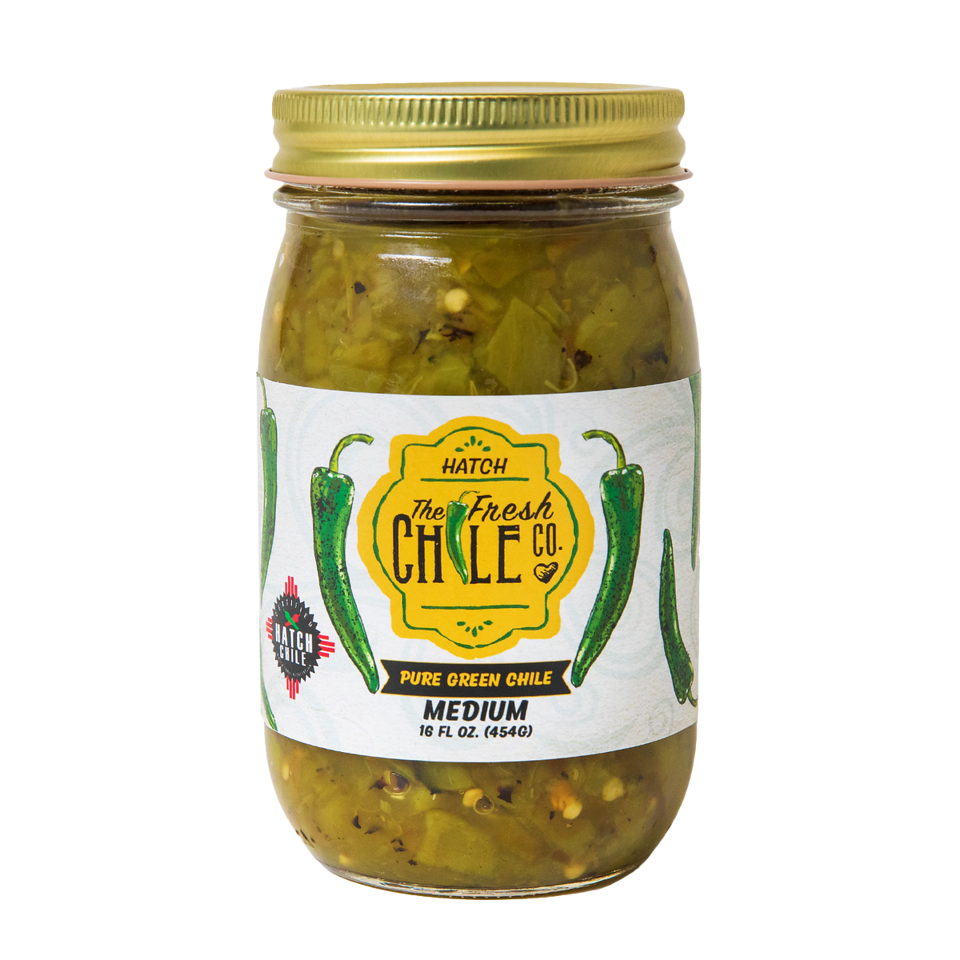 A jar of Pure Hatch Green Chile from the fresh chile co., labeled as medium heat, containing 16 oz. visible green chile pieces and seasoning within a sealed glass jar.