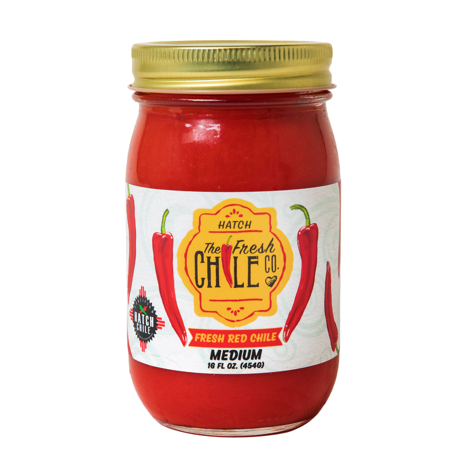 A jar of Fresh Hatch Red Chile Sauce with medium spice level, featuring bright red chiles on the label. The jar contains 16 fl. oz. (454g) of sauce, made gluten-free