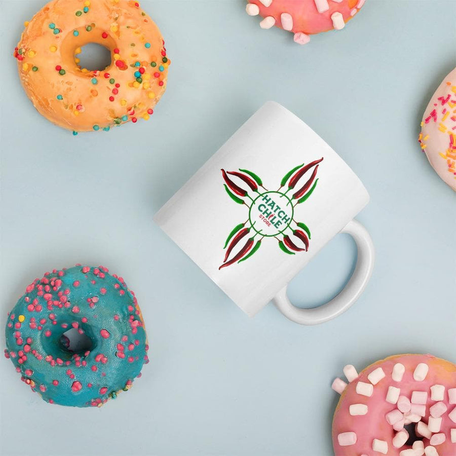 Chile Zia coffee mug surrounded by frosted donuts