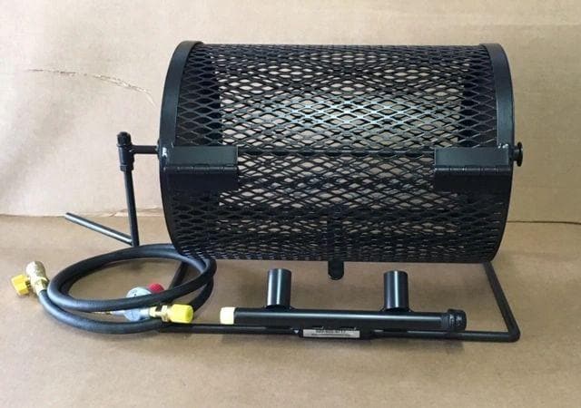 A black Small Table Top Roaster with a protective grille sits on a stand, connected to a gas hose and regulator on a cardboard background.